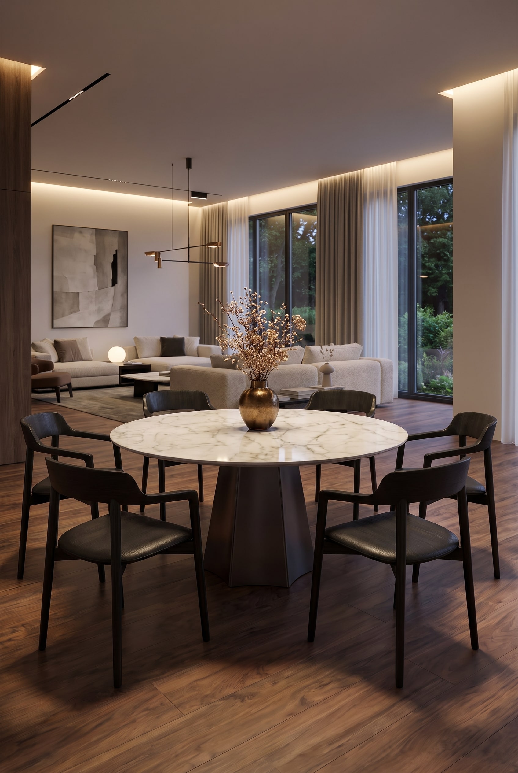 Une élégante table à manger en céramique Livitalia Poliedro à l'aspect marbre clair, centrée dans une cuisine-salon ouverte, entourée de chaises de salle à manger sombres.
