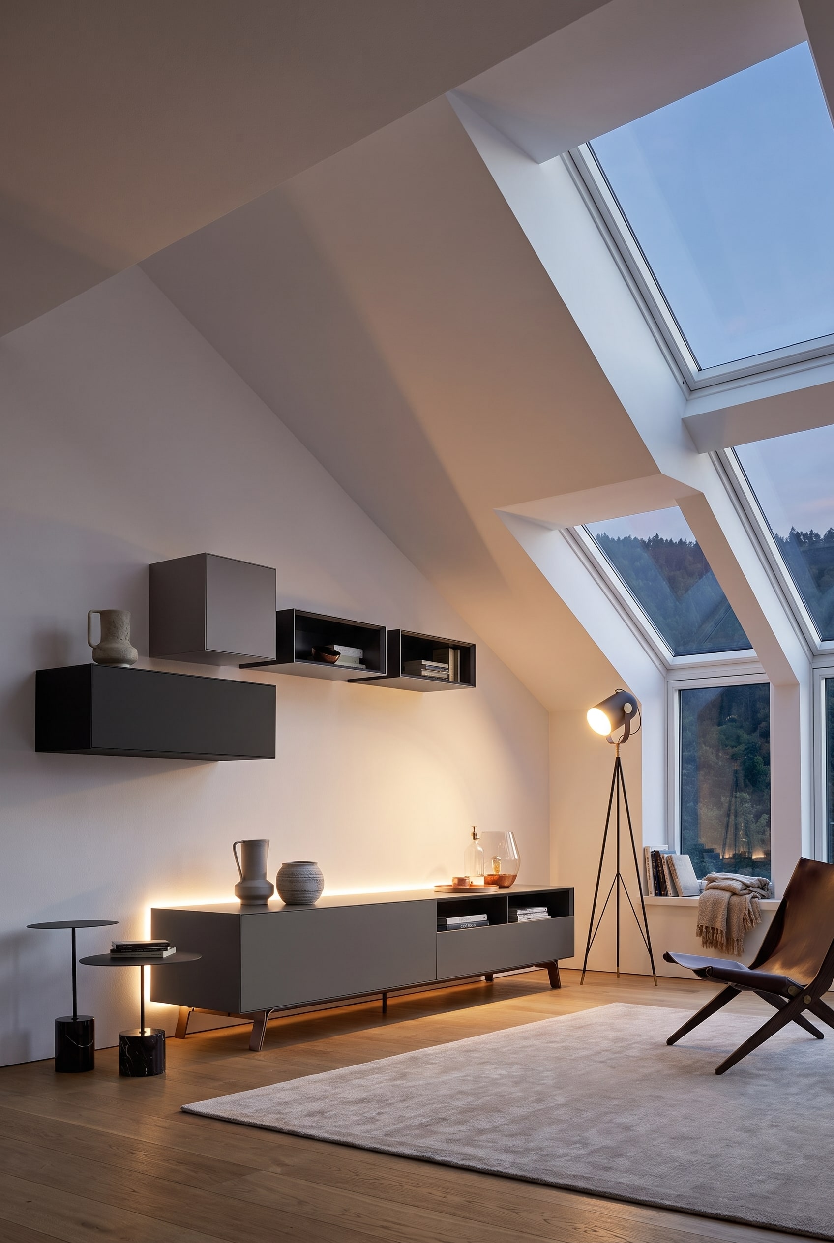 Meubles hauts modulaires blancs, adaptés en forme d'escalier à l'inclinaison d'une pente de toit